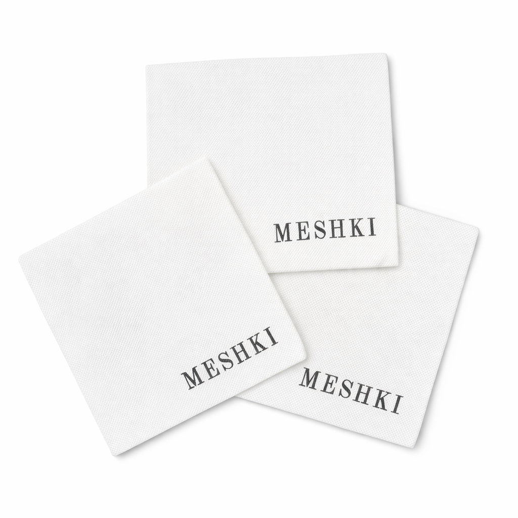 White Custom Napkins with 'MESHKI' branding on a white background